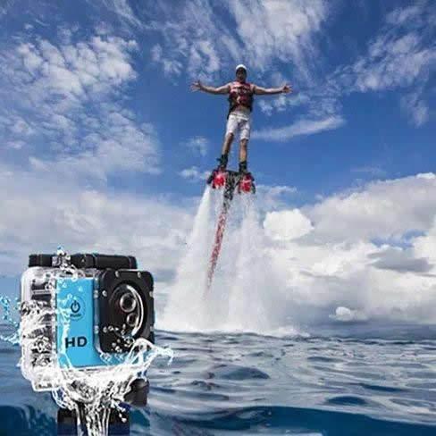4K waterproof action camera capturing person flyboarding over ocean with blue sky