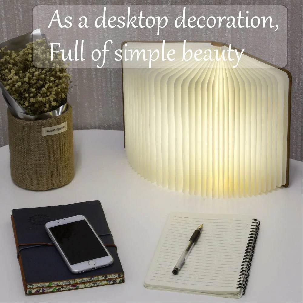 Yellow Pandora ambient bookshelf decor light glowing on a desk with notebook, phone, and dried flowers