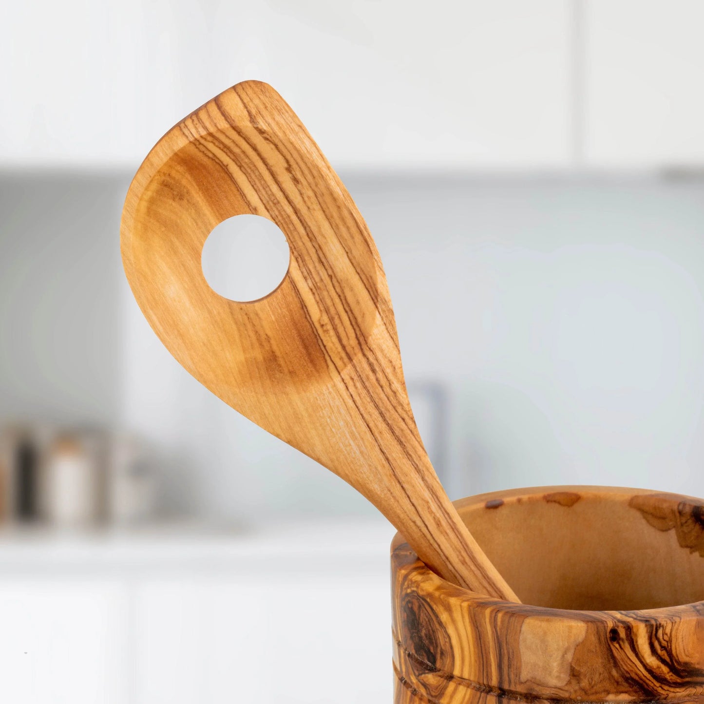 Turquoise Lucy handmade olive wood kitchen utensils with smooth finish in modern kitchen setting