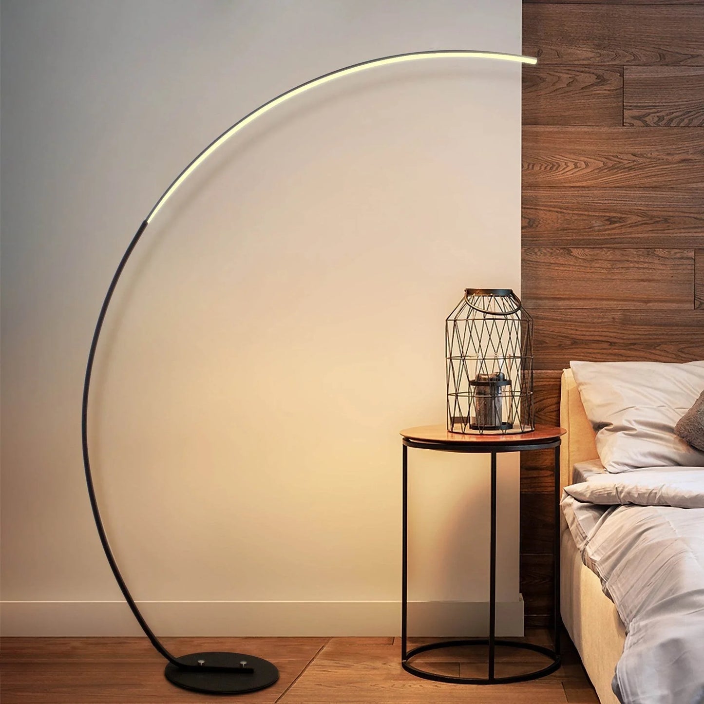 Sangria Apricot modern curve floor lamp with sleek black base and arc design in cozy bedroom setting