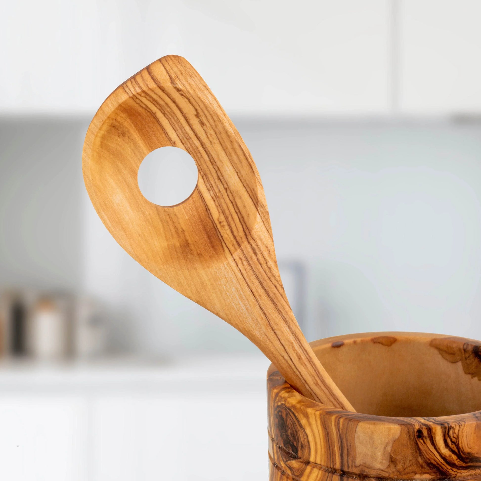Turquoise Lucy handmade olive wood kitchen utensils with smooth finish in modern kitchen setting